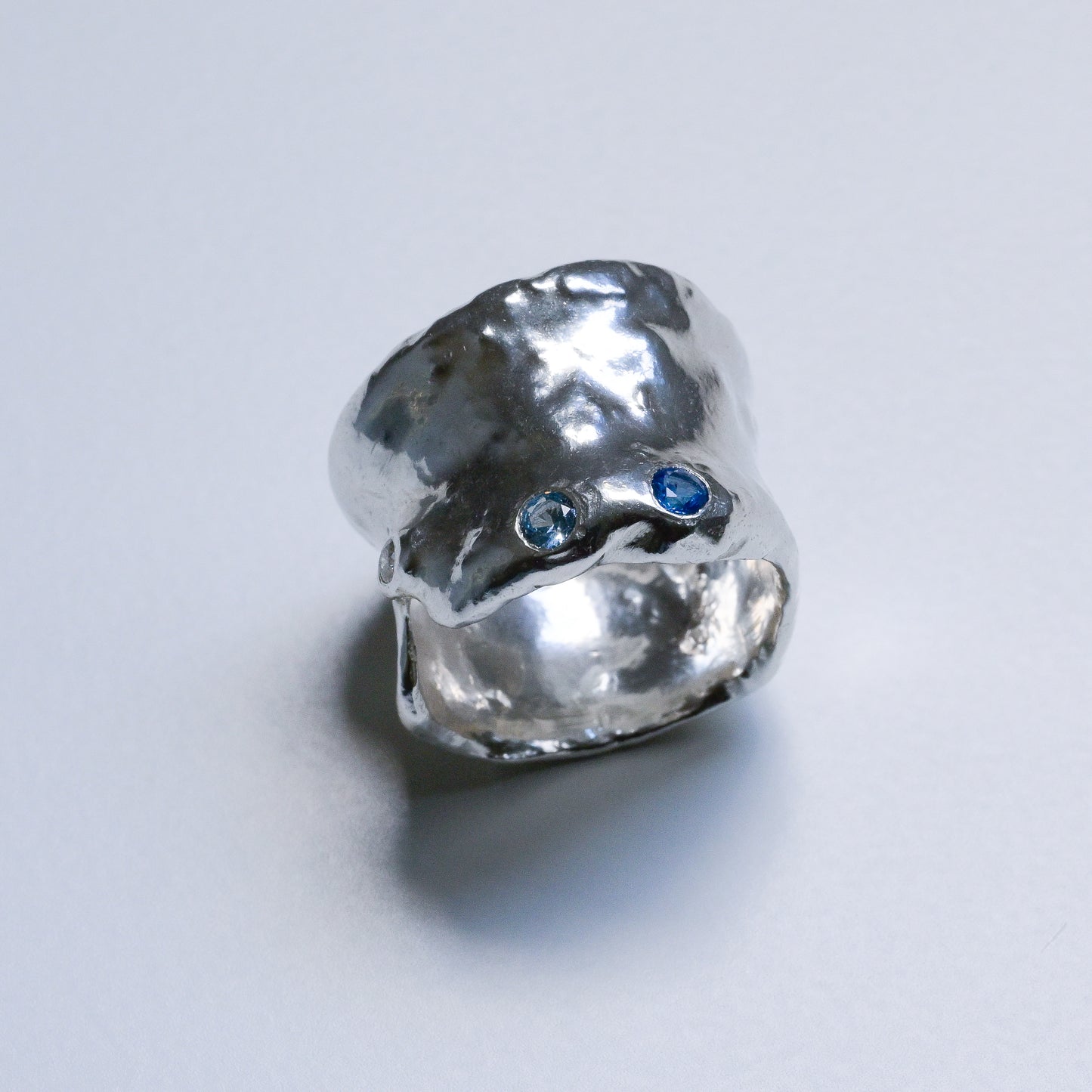 Detail close-up of Melted Silver Ring with sapphires and diamond Ocean