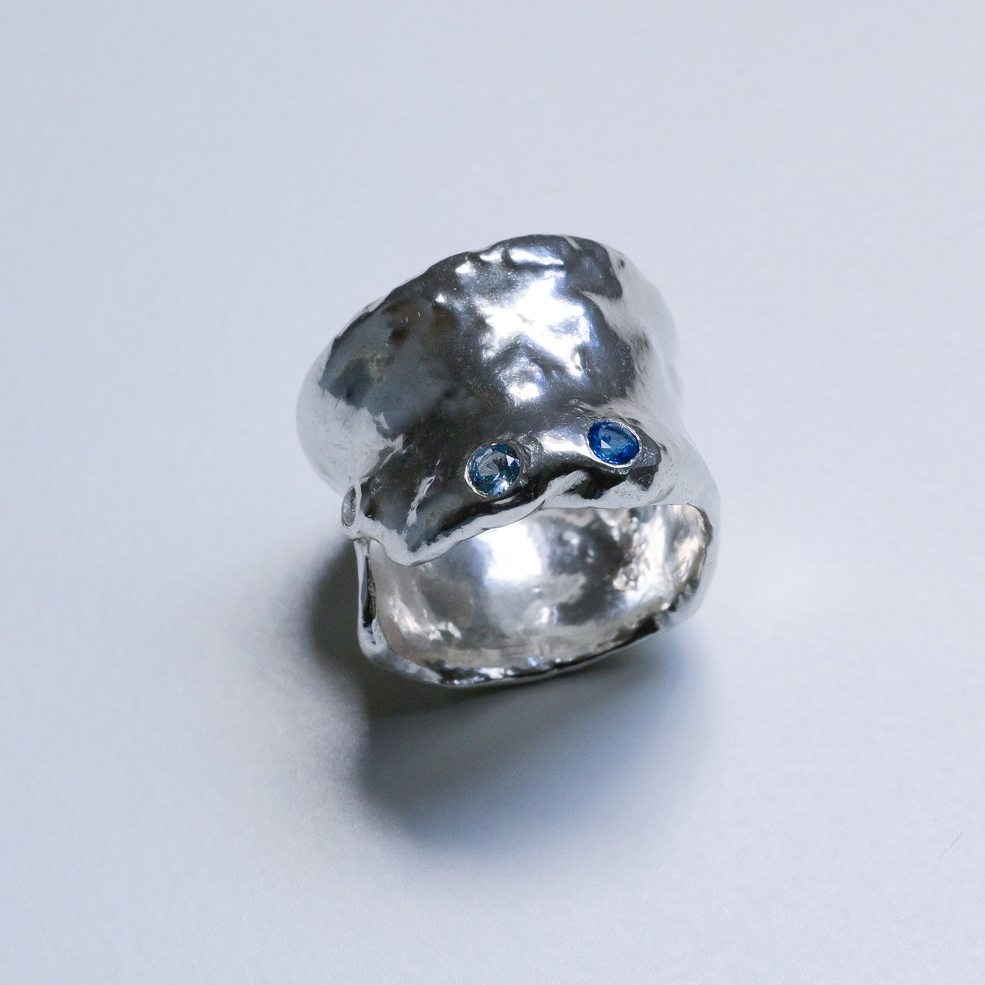 Detail close-up of Melted Silver Ring with sapphires and diamond Ocean