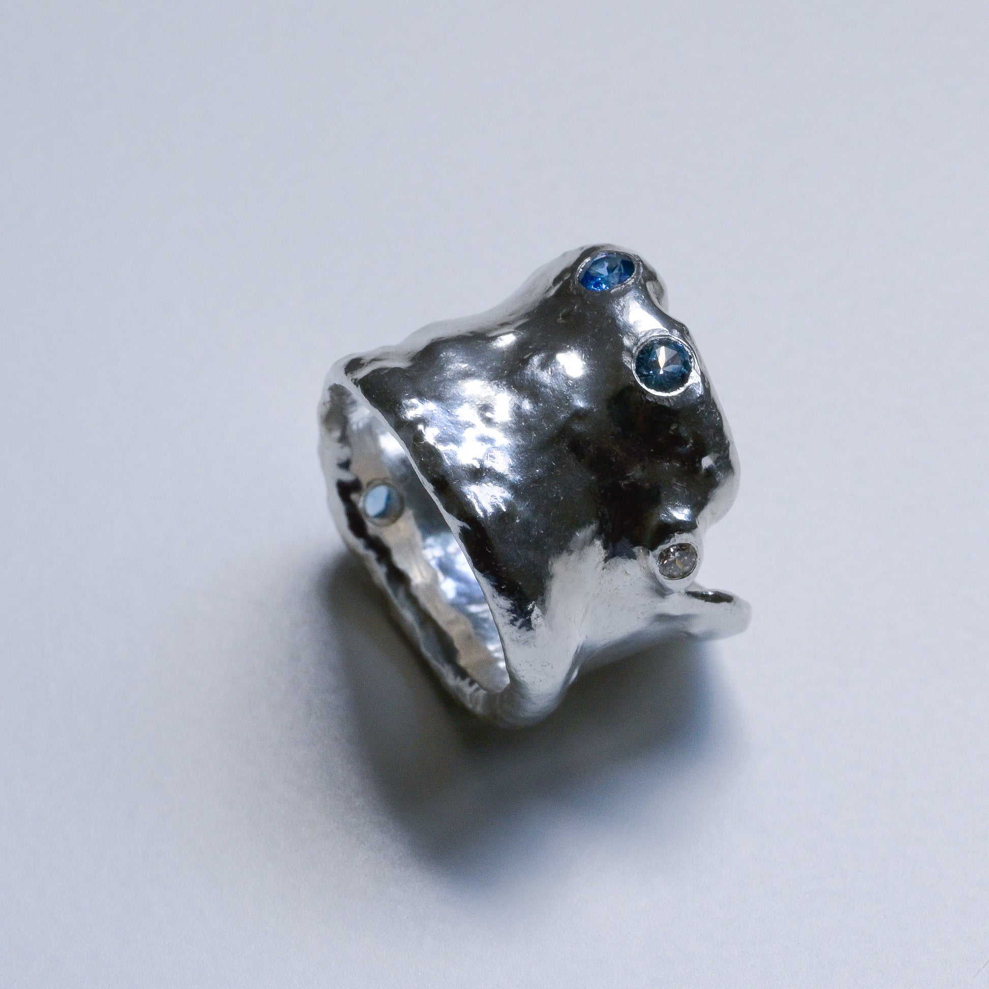 Profile view of Melted Silver Ring with sapphires and diamond Ocean