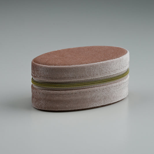 Blush oval velvet jewellery box with gold zip, closed