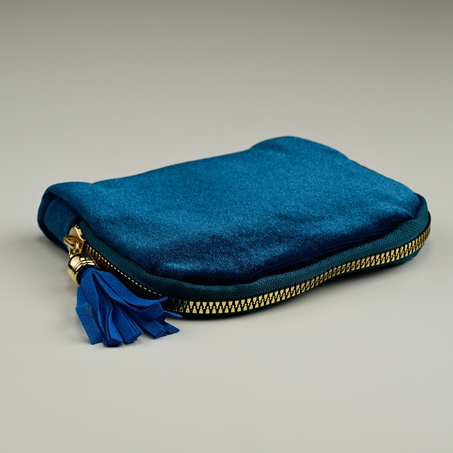 Teal velvet jewellery pouch with gold zip and leather tassel