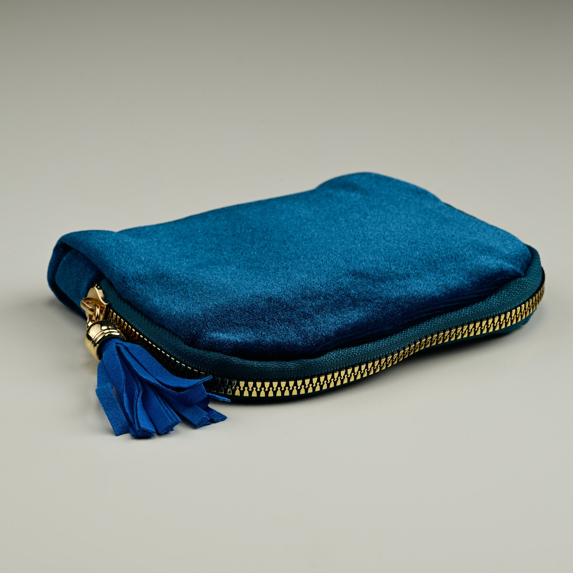 Teal velvet jewellery pouch with gold zip and leather tassel